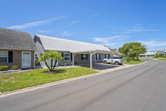 6702 Dartmoor Ln Unit 7A, New Port Richey, FL 34653 - view of front of house featuring a front lawn and a carport