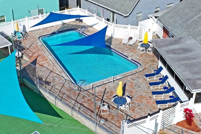 6702 Dartmoor Ln Unit 7A, New Port Richey, FL 34653 - community pool featuring a fenced backyard and a patio area