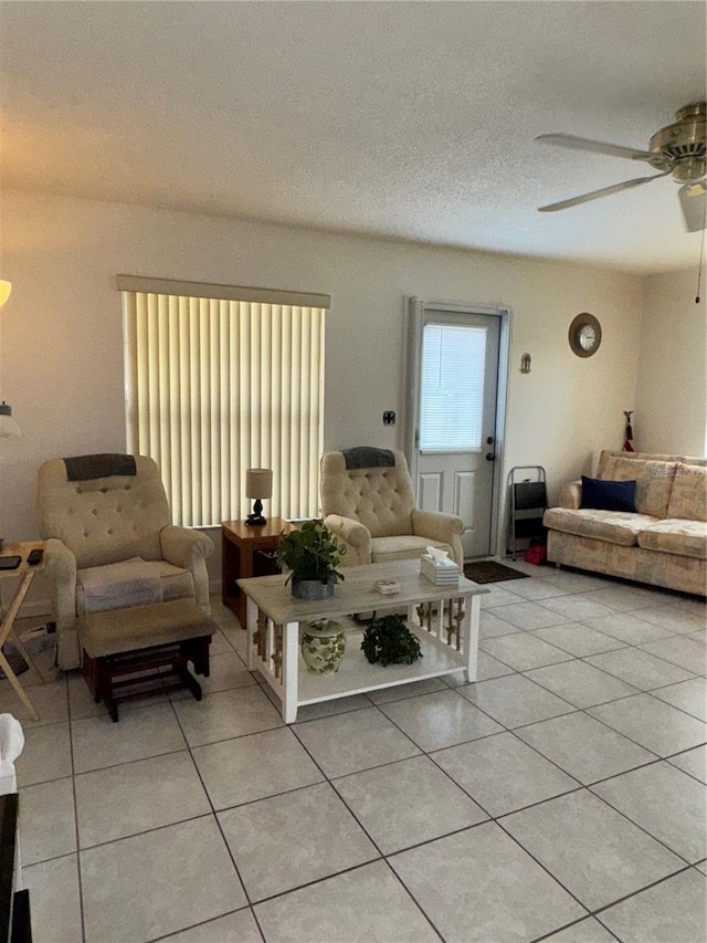 12104 Boynton Ln, New Port Richey, FL 34654 - living area featuring a ceiling fan, light tile patterned floors, and a textured ceiling