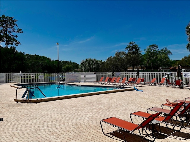 12104 Boynton Ln, New Port Richey, FL 34654 - community pool featuring a patio area