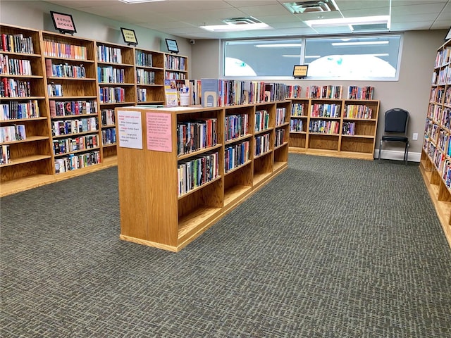 12104 Boynton Ln, New Port Richey, FL 34654 - miscellaneous room with bookshelves, carpet, and a paneled ceiling