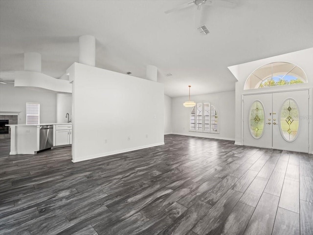 15430 Oakcrest Cir, Brooksville, FL 34604 - unfurnished living room with a ceiling fan, high vaulted ceiling, dark wood-type flooring, and a tile fireplace