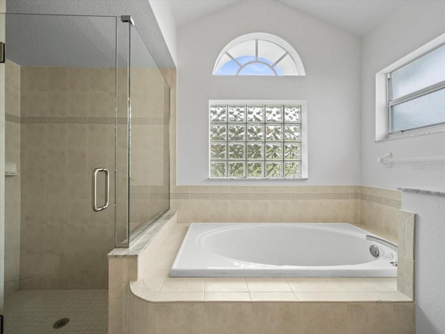 15430 Oakcrest Cir, Brooksville, FL 34604 - bathroom featuring a garden tub, a stall shower, healthy amount of natural light, and vaulted ceiling