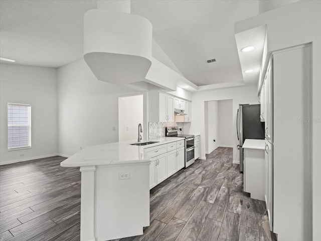 15430 Oakcrest Cir, Brooksville, FL 34604 - kitchen featuring appliances with stainless steel finishes, a peninsula, light countertops, dark wood finished floors, and recessed lighting