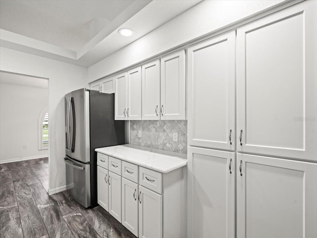 15430 Oakcrest Cir, Brooksville, FL 34604 - kitchen featuring freestanding refrigerator, white cabinetry, recessed lighting, light stone countertops, and tasteful backsplash