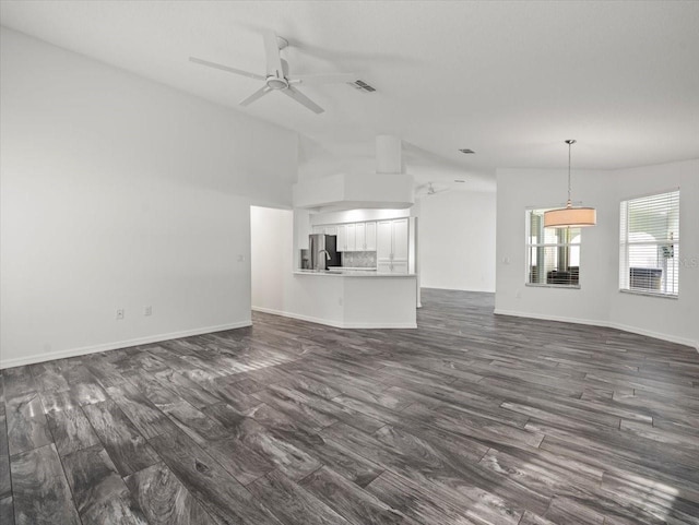 15430 Oakcrest Cir, Brooksville, FL 34604 - unfurnished living room featuring lofted ceiling, dark wood-style floors, and ceiling fan