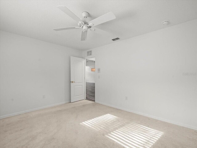 15430 Oakcrest Cir, Brooksville, FL 34604 - unfurnished bedroom featuring light colored carpet and a ceiling fan