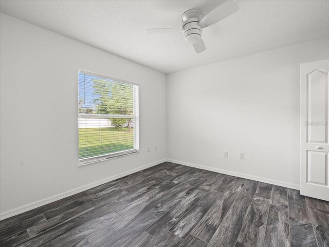 15430 Oakcrest Cir, Brooksville, FL 34604 - empty room featuring dark wood-style floors and ceiling fan
