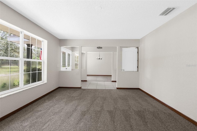 14645 Spellman Ct, Spring Hill, FL 34610 - empty room featuring carpet, plenty of natural light, a chandelier, and a textured ceiling