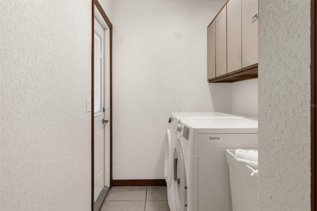 14645 Spellman Ct, Spring Hill, FL 34610 - washroom featuring cabinet space, washer and clothes dryer, light tile patterned floors, and a textured wall