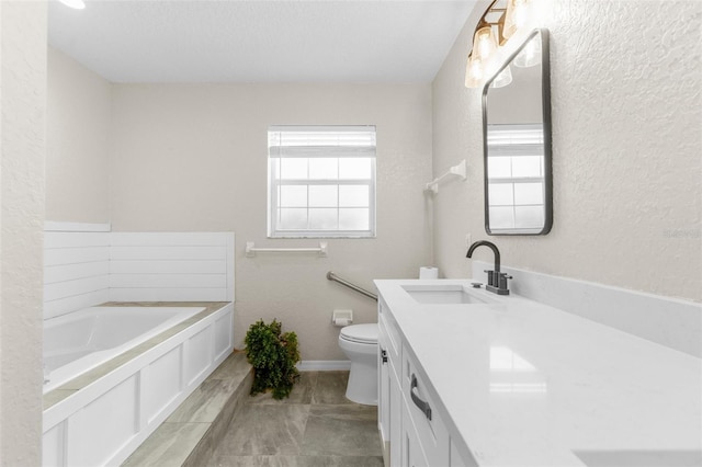 14645 Spellman Ct, Spring Hill, FL 34610 - bathroom featuring a garden tub, vanity, and a textured wall