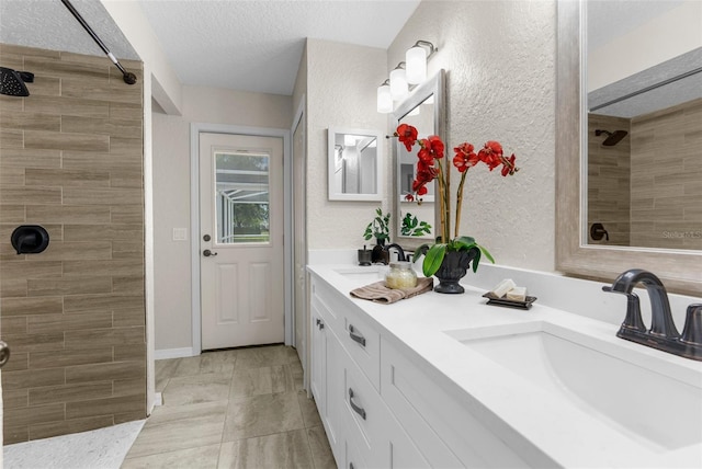14645 Spellman Ct, Spring Hill, FL 34610 - full bath featuring a tile shower, double vanity, a textured wall, and a textured ceiling