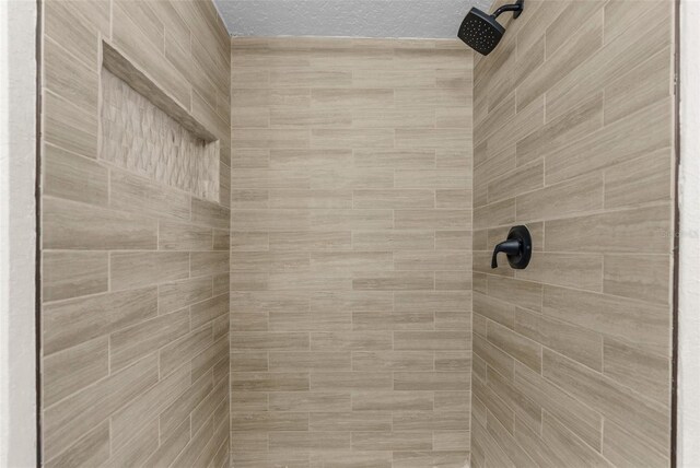 14645 Spellman Ct, Spring Hill, FL 34610 - bathroom view of tiled shower and a textured ceiling