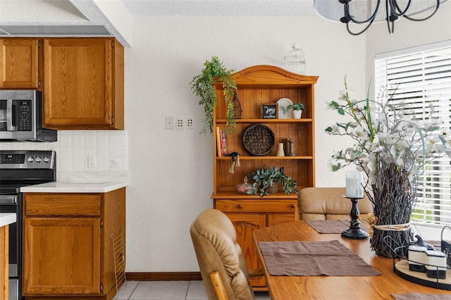 14645 Spellman Ct, Spring Hill, FL 34610 - dining area featuring a chandelier and light tile patterned floors