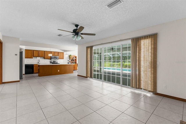 14645 Spellman Ct, Spring Hill, FL 34610 - unfurnished living room featuring ceiling fan, a textured ceiling, and light tile patterned floors