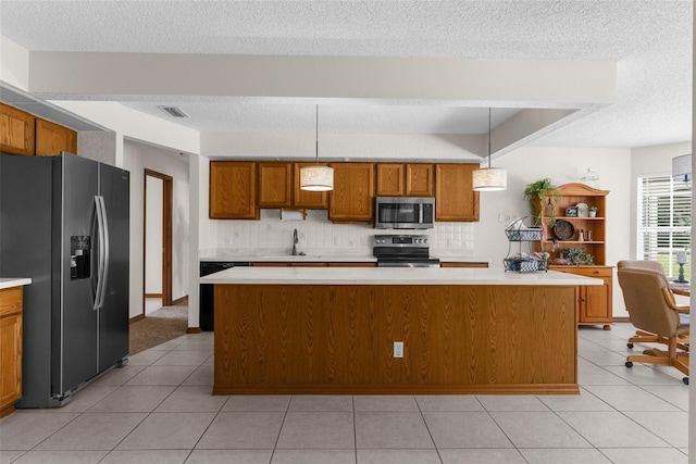 14645 Spellman Ct, Spring Hill, FL 34610 - kitchen with appliances with stainless steel finishes, light countertops, brown cabinets, a textured ceiling, and tasteful backsplash