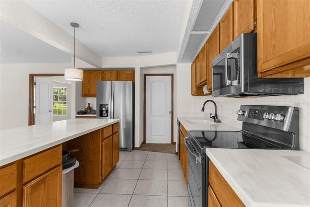 14645 Spellman Ct, Spring Hill, FL 34610 - kitchen with stainless steel appliances, brown cabinets, light countertops, a textured ceiling, and decorative backsplash