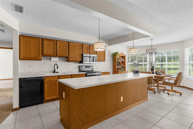 14645 Spellman Ct, Spring Hill, FL 34610 - kitchen featuring stainless steel appliances, a textured ceiling, brown cabinetry, light countertops, and a center island