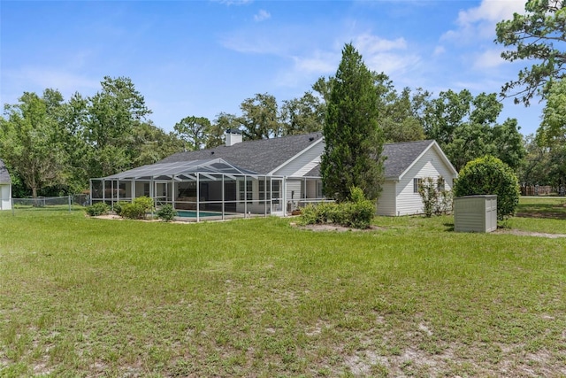 14645 Spellman Ct, Spring Hill, FL 34610 - rear view of house with a chimney, a lanai, roof with shingles, and an outdoor pool