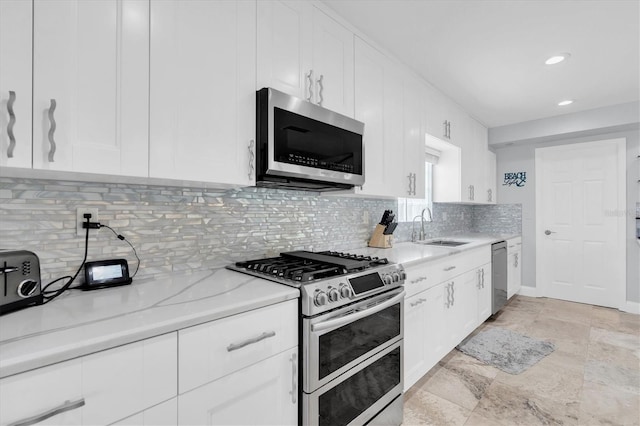3701 Corsair Ct, New Port Richey, FL 34652 - kitchen with stainless steel appliances, white cabinetry, tasteful backsplash, recessed lighting, and light stone counters