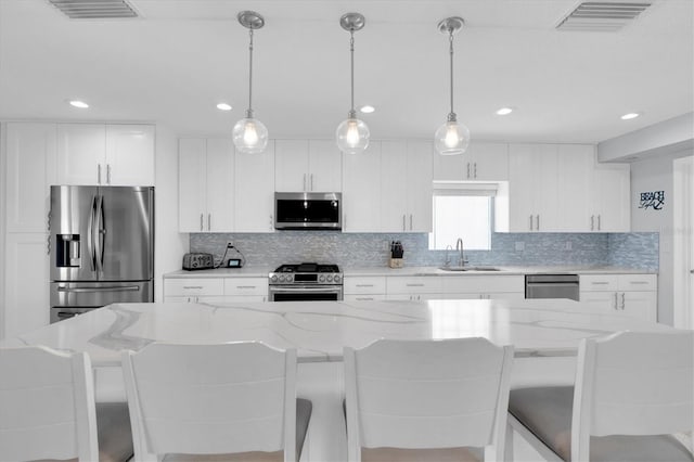 3701 Corsair Ct, New Port Richey, FL 34652 - kitchen featuring stainless steel appliances, backsplash, white cabinets, and recessed lighting