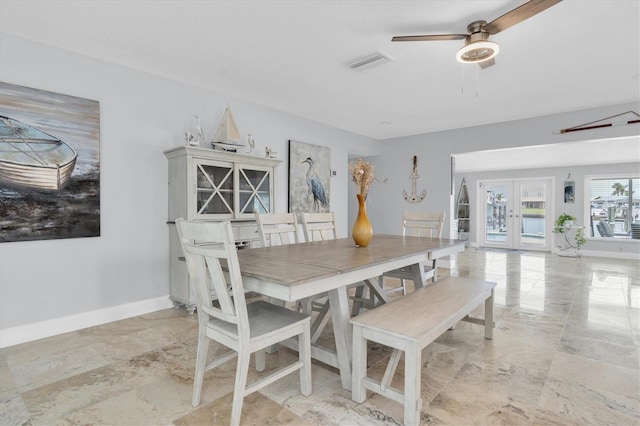 3701 Corsair Ct, New Port Richey, FL 34652 - dining space featuring a ceiling fan, french doors, and light marble finish floors