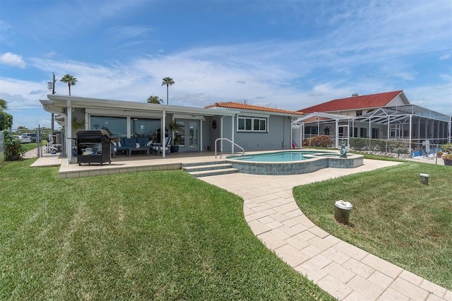 3701 Corsair Ct, New Port Richey, FL 34652 - rear view of house featuring an in-ground hot tub, a patio, a yard, and outdoor lounge area