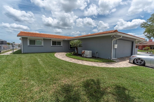 3701 Corsair Ct, New Port Richey, FL 34652 - view of front of home with an attached garage, a tiled roof, and stucco siding