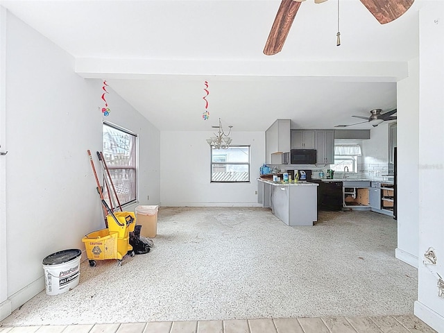 336 Boca Ciega Dr, Madeira Beach, FL 33708 - kitchen with gray cabinetry, ceiling fan, black microwave, open floor plan, and light countertops