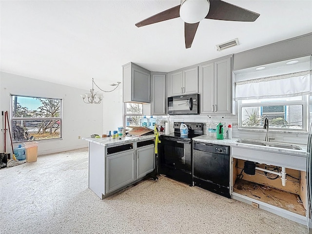 336 Boca Ciega Dr, Madeira Beach, FL 33708 - kitchen with black appliances, gray cabinetry, a peninsula, a chandelier, and ceiling fan