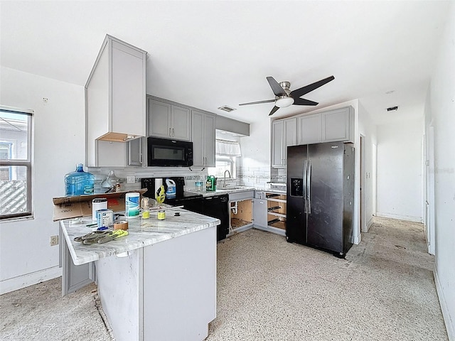 336 Boca Ciega Dr, Madeira Beach, FL 33708 - kitchen featuring black appliances, gray cabinetry, backsplash, a peninsula, and a ceiling fan