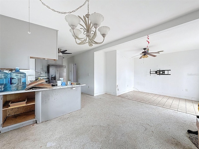 336 Boca Ciega Dr, Madeira Beach, FL 33708 - kitchen with stainless steel refrigerator with ice dispenser, gray cabinets, a ceiling fan, a chandelier, and light countertops