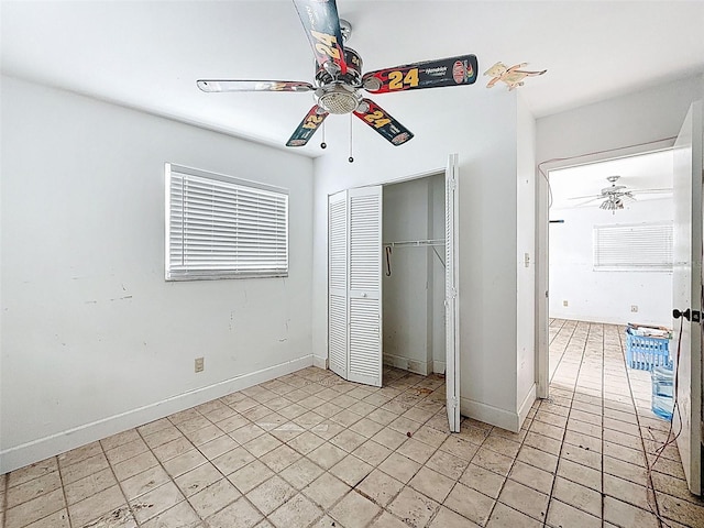 336 Boca Ciega Dr, Madeira Beach, FL 33708 - unfurnished bedroom featuring a closet, light tile patterned flooring, and ceiling fan