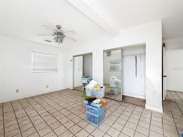 336 Boca Ciega Dr, Madeira Beach, FL 33708 - empty room featuring a ceiling fan, light tile patterned floors, and beam ceiling