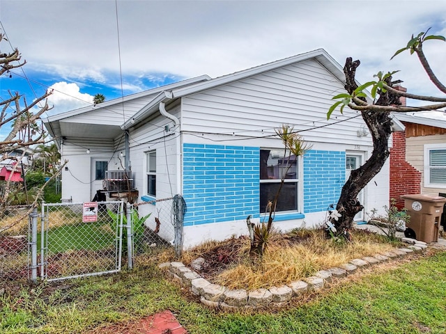 336 Boca Ciega Dr, Madeira Beach, FL 33708 - back of house featuring a gate and brick siding