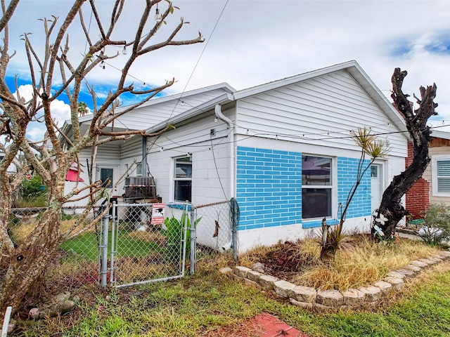 336 Boca Ciega Dr, Madeira Beach, FL 33708 - view of property exterior with brick siding and a gate