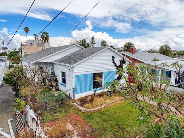 336 Boca Ciega Dr, Madeira Beach, FL 33708 - rear view of property featuring a shingled roof and a gate
