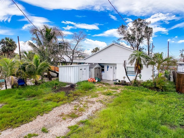 336 Boca Ciega Dr, Madeira Beach, FL 33708 - back of property featuring a storage shed and driveway