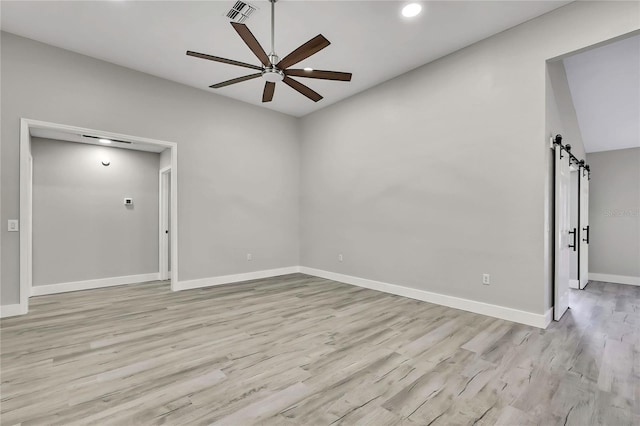4360 Talco Ave, Spring Hill, FL 34609 - spare room featuring a barn door, a ceiling fan, light wood finished floors, and recessed lighting