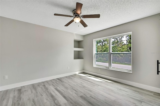 4360 Talco Ave, Spring Hill, FL 34609 - unfurnished room featuring a textured ceiling, wood finished floors, a ceiling fan, and built in features
