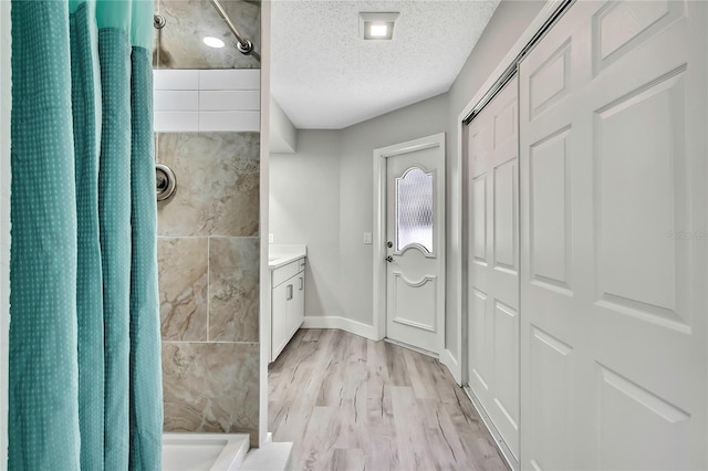 4360 Talco Ave, Spring Hill, FL 34609 - bathroom with curtained shower, wood finished floors, a textured ceiling, and vanity