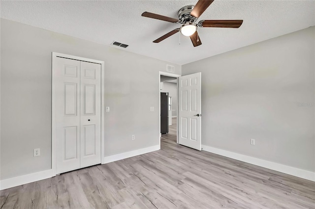 4360 Talco Ave, Spring Hill, FL 34609 - unfurnished bedroom featuring wood finished floors, a closet, a textured ceiling, and ceiling fan