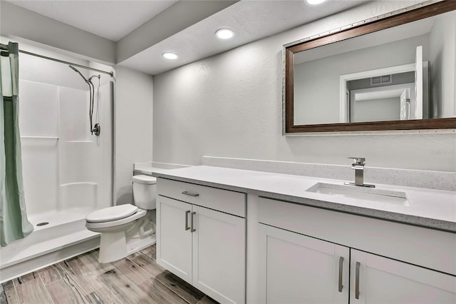 4360 Talco Ave, Spring Hill, FL 34609 - full bath with vanity, a stall shower, recessed lighting, and wood finished floors