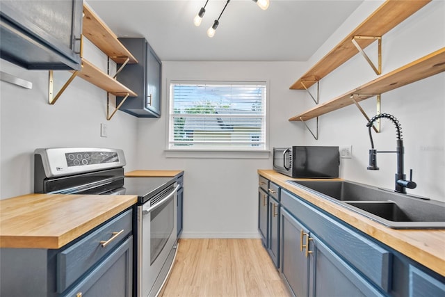 4622 Paloverde Dr, New Port Richey, FL 34652 - kitchen featuring open shelves, stainless steel electric range oven, butcher block countertops, and black microwave