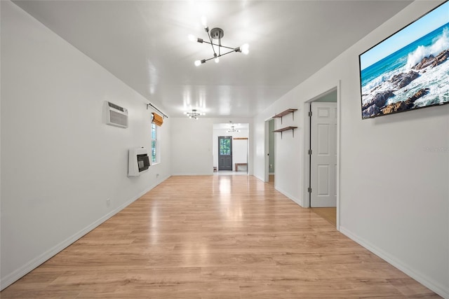 4622 Paloverde Dr, New Port Richey, FL 34652 - unfurnished living room with a chandelier, heating unit, light wood finished floors, and a wall mounted air conditioner