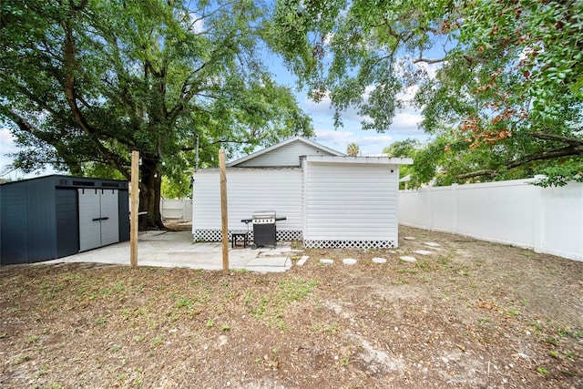 4622 Paloverde Dr, New Port Richey, FL 34652 - back of house with a shed, a fenced backyard, a patio, and a garage