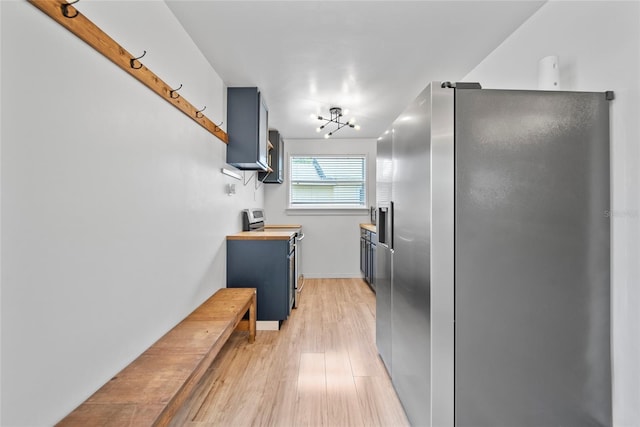 4622 Paloverde Dr, New Port Richey, FL 34652 - kitchen with appliances with stainless steel finishes, light wood finished floors, and blue cabinets