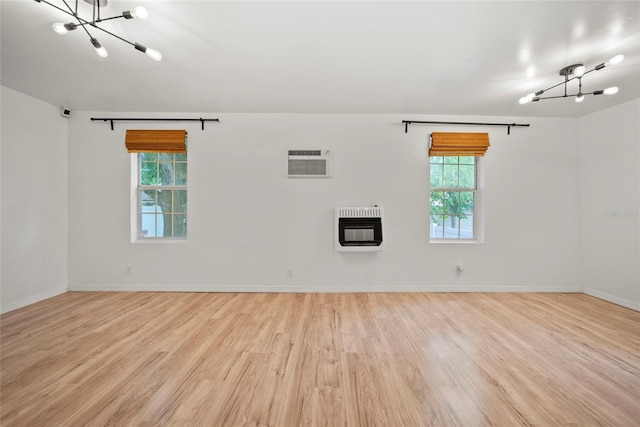4622 Paloverde Dr, New Port Richey, FL 34652 - unfurnished room with a chandelier, heating unit, wood finished floors, and an AC wall unit