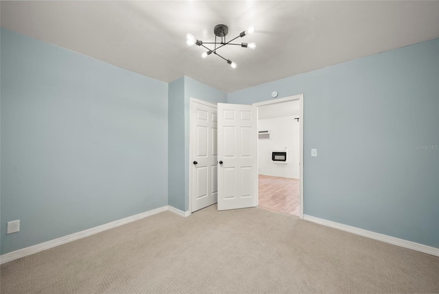4622 Paloverde Dr, New Port Richey, FL 34652 - unfurnished bedroom with a chandelier, light carpet, and a closet