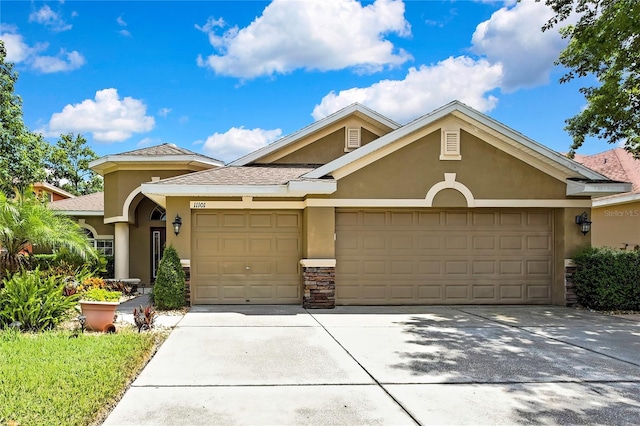 11101 Ragsdale Ct, New Port Richey, FL 34654 - view of front facade featuring stucco siding, a garage, concrete driveway, and a shingled roof
